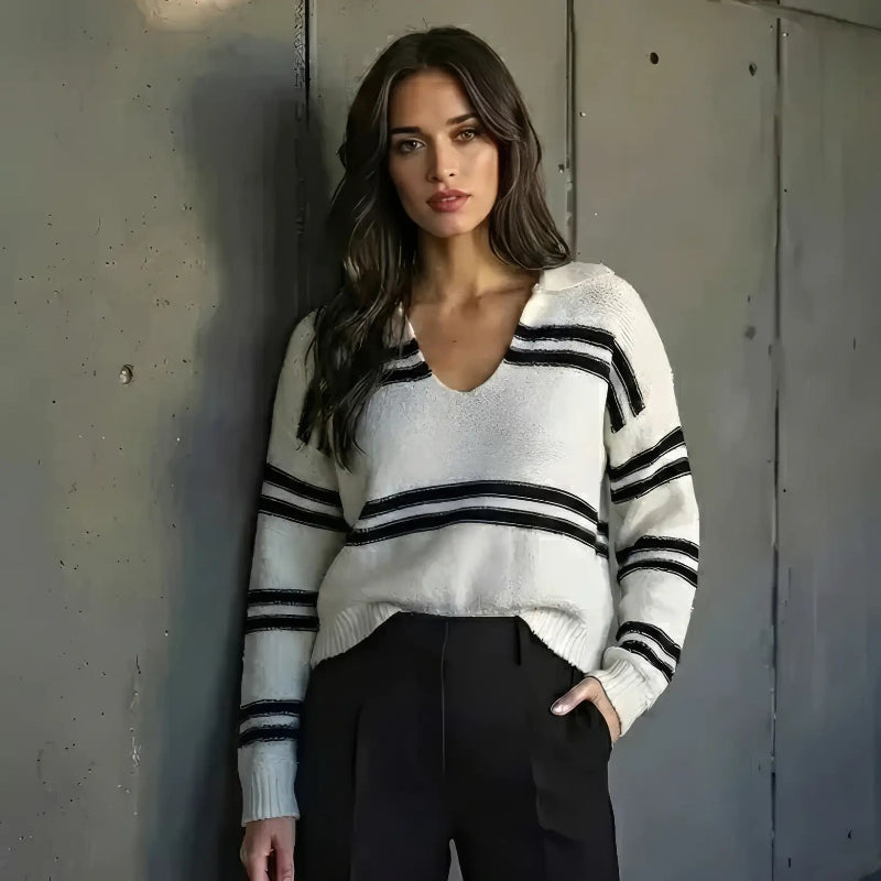 Sassy Model wearing a sweatshirt standing in front of a concrete wall